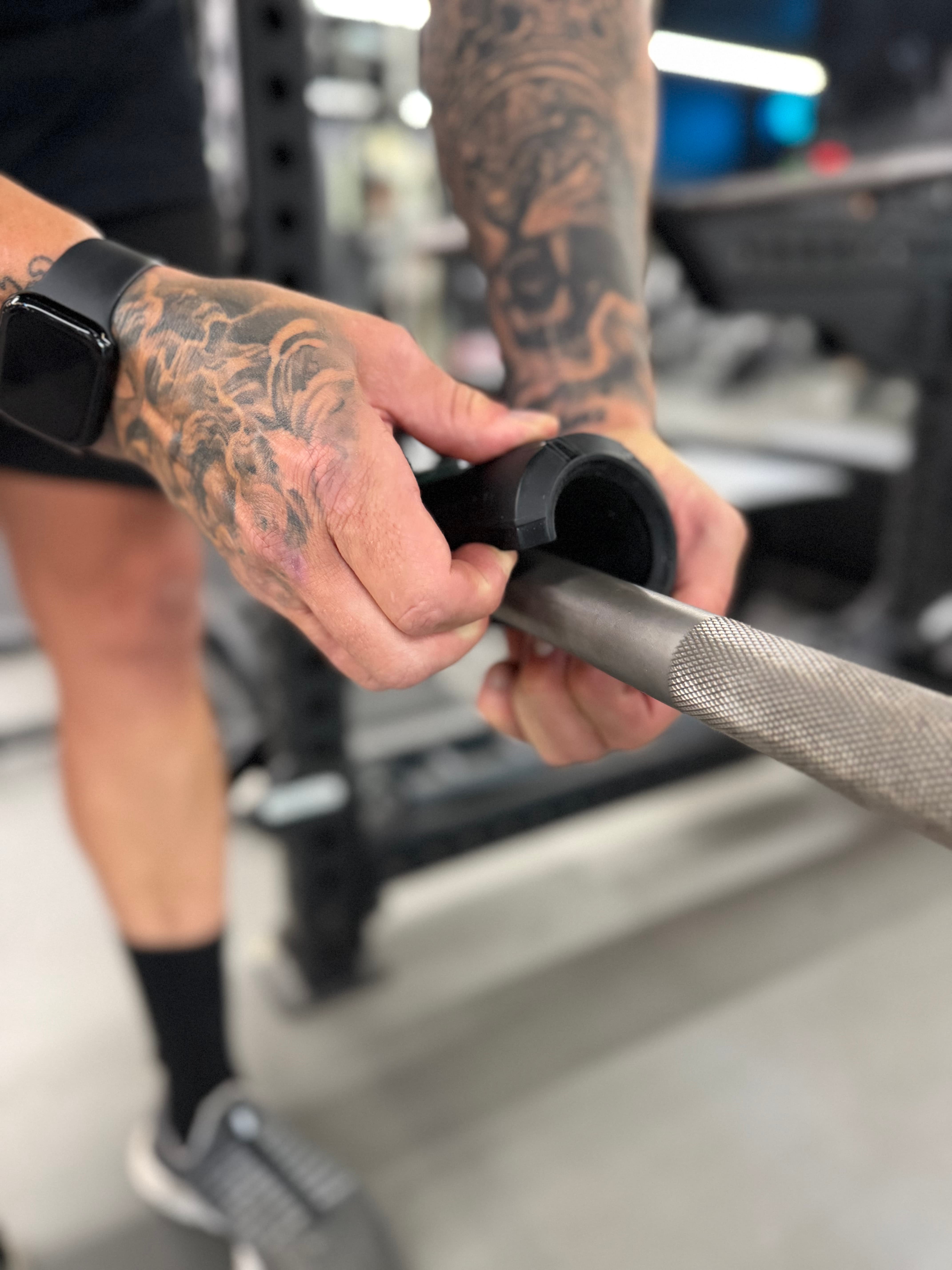 Sniperform LevelUp grip clipping onto a barbell
